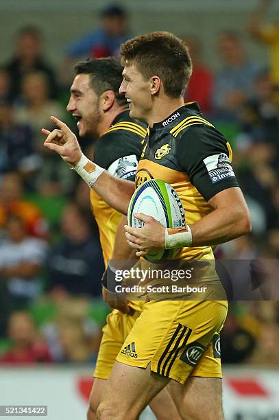 Beauden Barrett of the Hurricanes is congratulated by his teammates after scoring a try during the round eight Super Rugby match between the Rebels...