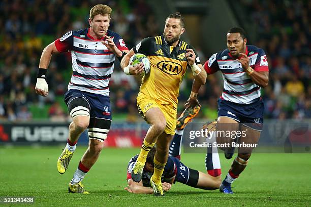 Cory Jane of the Hurricanes beats the Rebels defence to score a try during the round eight Super Rugby match between the Rebels and the Hurricanes at...