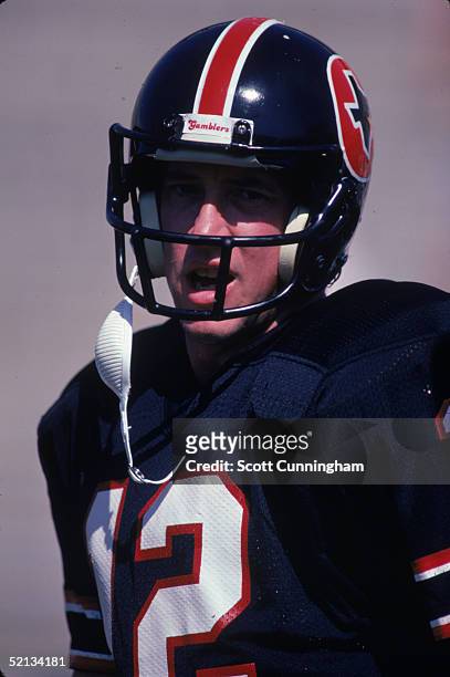 Quarterback Jim Kelly of the Houston Gamblers concentrates on play from the sideline during a 1985 season USFL game.