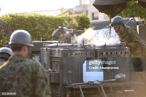 The Japan Self-Defense Forces members operate a soup-run at the evacuation center a day after the 2016 Kumamoto Earthquake at the Mashiki Town Hall...