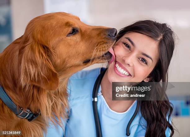 dog giving kiss to the vet - animals kissing stockfoto's en -beelden