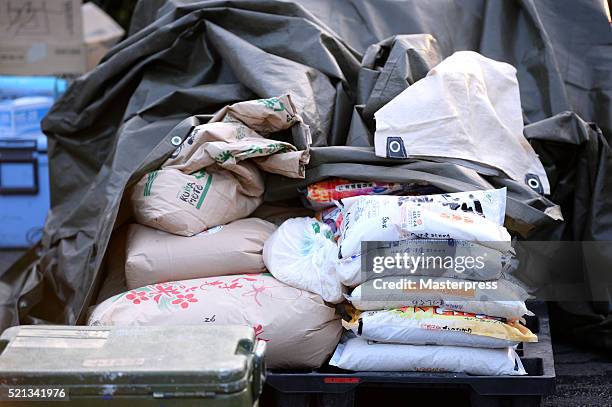 Stack of rice bags are seen at the soup-run operated at the evacuation center a day after the 2016 Kumamoto Earthquake at the Mashiki Town Hall on...