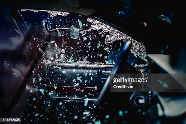 car thief breaking car window - thief stock pictures, royalty-free photos & images
