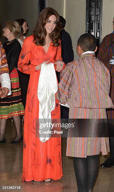 Catherine, Duchess of Cambridge is presented a silk scarf by Ugyen Michael Wangchukat at a reception celebrating UK and Bhutanese friendship and...