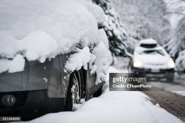 snow-covered street and car - smeltende sneeuw stockfoto's en -beelden