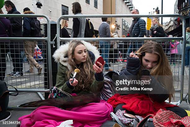 Girls waiting to see their favourite movie stars outside the BAFTA Awards ceremony in London, England, United Kingdom. Izzy and Bella do their make...