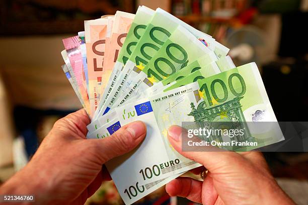 a handful of euros bills - euro currency stock pictures, royalty-free photos & images