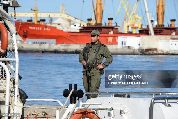 Tunisian soldier stands guard in the port of Sfax after residents blocked access to a ferry on April 15, 2016 in an attempt to prevent the police...