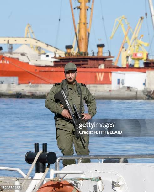Tunisian soldier stands guard in the port of Sfax after residents blocked access to a ferry on April 15, 2016 in an attempt to prevent the police...
