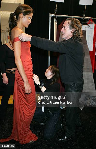 Fashion designer Richard Tyler prepares a model backstage at the Richard Tyler/Delta Fall 2005 show during the Olympus Fashion Week at Bryant Park...
