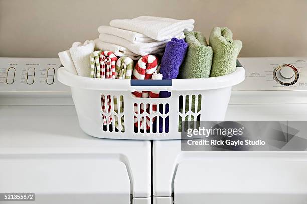 clean folded towels in laundry basket on top of washer and dryer - dryer stock-fotos und bilder