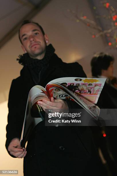 Teen Style Designer Kevin Michael reads the Daily at Olympus Fashion Week Fall 2005 at Bryant Park February 04, 2004 in New York City.