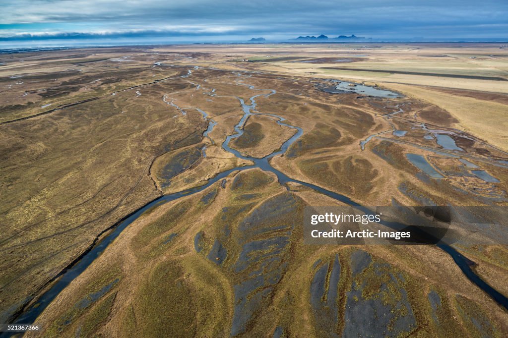 Aerial of rivers, earth mound, farmland, Iceland