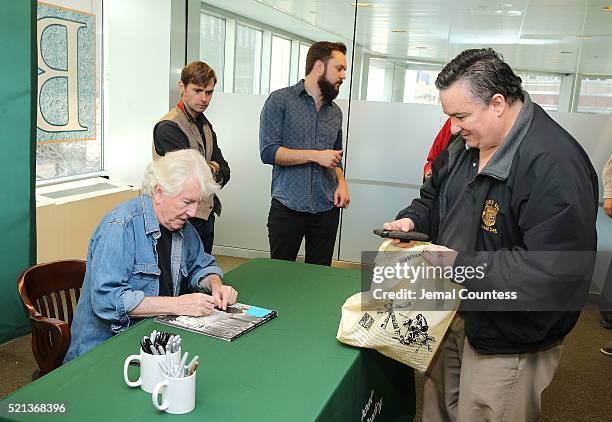 Musician Graham Nash signs a copy of his new album "The Path Tonight" during an in-store signing event for his new album "The Path Tonight" at Barnes...