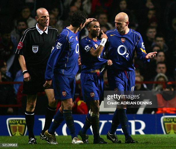 Arsenal's Ashley Cole is congratulated by teammates Edu and Pascal Cygan after he scored Arsenal's third goal against Aston Villa during the...