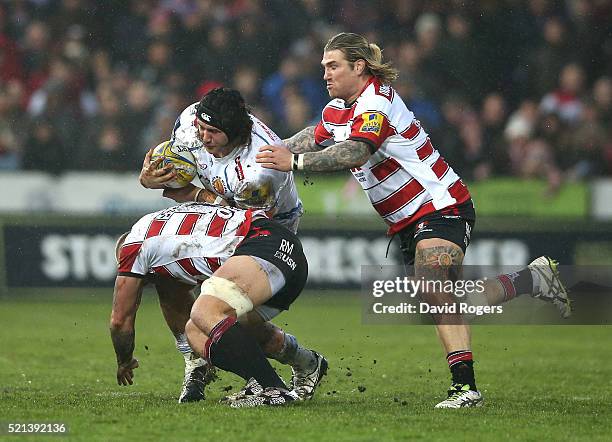 Harry Williams of Exeter is tackled by Ross Moriarty and Richard Hibbard during the Aviva Premiership match between Gloucester and Exeter Chiefs at...