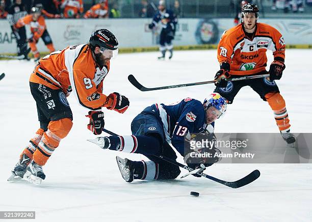 Michael Wolf of Red Bull Muenchen os challenged by Jeff Likens of the Grizzlys tangles during the DEL Ice Hockey Playoffs Final Game One between EHC...