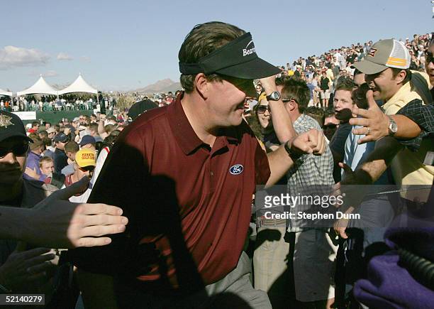 Phil Mickelson makes his way through the crowd after finishing the 16th hole during the third round of the FBR Open on February 5, 2005 at the...