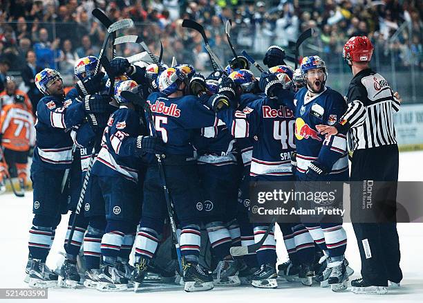 Jeremey Dehner of Red Bull Muenchen is congratulated after scoring the winning goal during the DEL Ice Hockey Playoffs Final Game One between EHC Red...