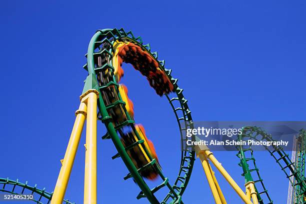 spiraling roller coaster - rollercoaster stock-fotos und bilder