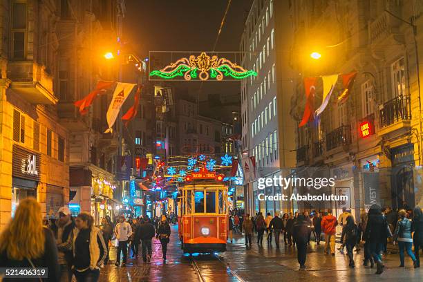 christmas lights, national flags and tramway in istanbul, turkey - istiklal avenue stock pictures, royalty-free photos & images