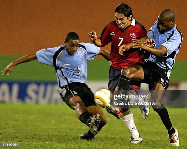 Fernando Meneses de la seleccion de Chile disputa el balon con Ribair Rodriguez y Alvaro Pereira de Uruguay durante el partido por el campeonato...