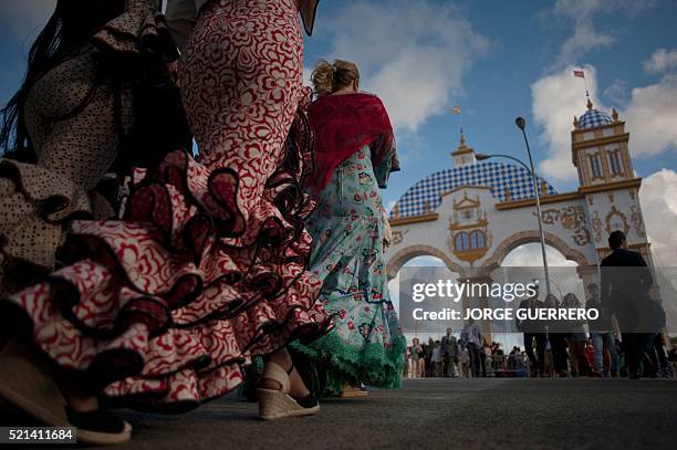 Women wear traditional Andalusian dresses during Sevilla's famed April fair on April 15, 2016. The Fair dates back to 1847 when it was originally...