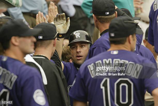 Todd Zeile of the Colorado Rockies is celebrated by teammates after hitting a two-run home run during the game against the Houston Astros at Coors...