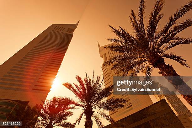 dubai, emirates towers at sunrise - emirates towers stockfoto's en -beelden