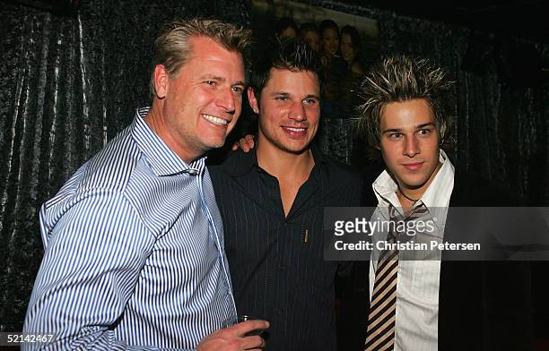Manager Joe Simpson, Nick Lachey and singer Ryan Cabere pose for a photograph at Super Bowl Playboy Party at the River City Brewing Company on...