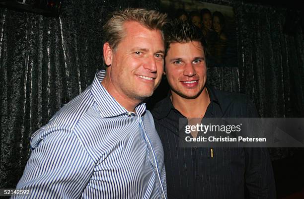 Manager Joe Simpson and tv personality Nick Lachey pose for a photograph at Super Bowl Playboy Party at the River City Brewing Company on February 5,...