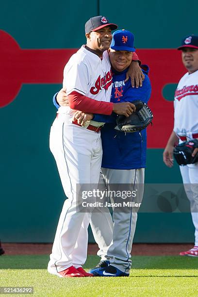 First base coach Sandy Alomar Jr. #15 of the Cleveland Indians greets starting pitcher Bartolo Colon of the New York Mets prior to the game at...