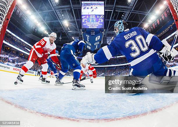 Goalie Ben Bishop of the Tampa Bay Lightning stretches to make a save against Joakim Andersson of the Detroit Red Wings during the first period of...