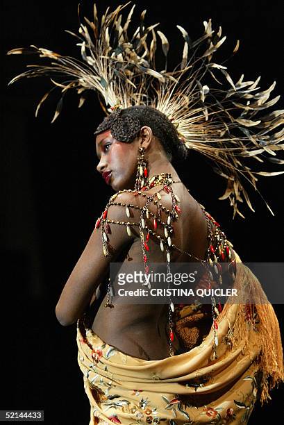 Model wears a creation with shawls by Spanish designer Manos Bordadoras during the Simof 'Salon International of Flamenco Fashion' show at the...