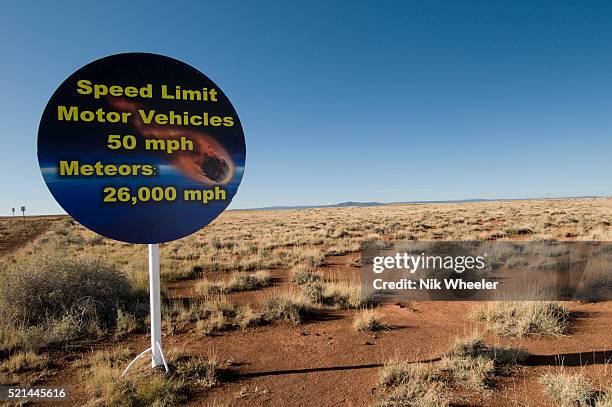 Lighthearted sign advertising Meteor Crater, the world's best preserved meteor impact site, off Interstate 40 and near Route 66, in Arizona. The...