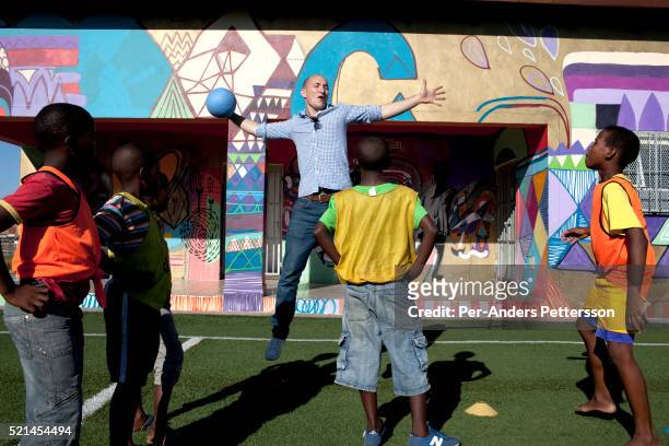 Florian Zech helps with a skills training session at Amandla EduFootball which was founded by Jakob Schlichti and Florian Zech in the field in...