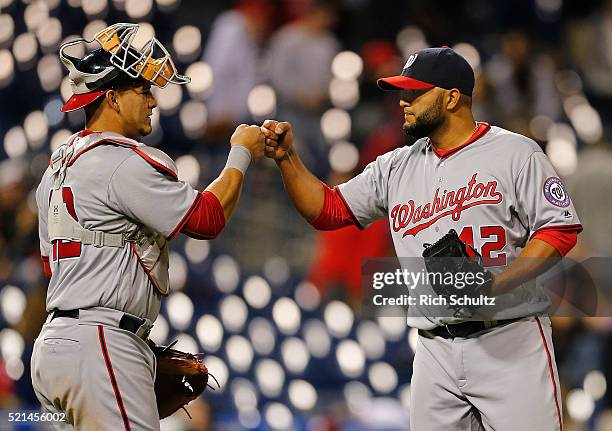 Yusmeiro Petit , right, of the Washington Nationals is congratulated by catcher Wilson Ramos, left, after they beat the Philadelphia Phillies 9-1 in...