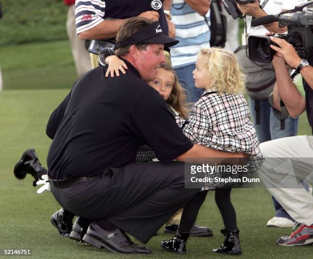 Phil Mickelson embraces daughters Amanda and Sophia after winning in the final round of the FBR Open on February 6, 2005 at the Tournament Players...