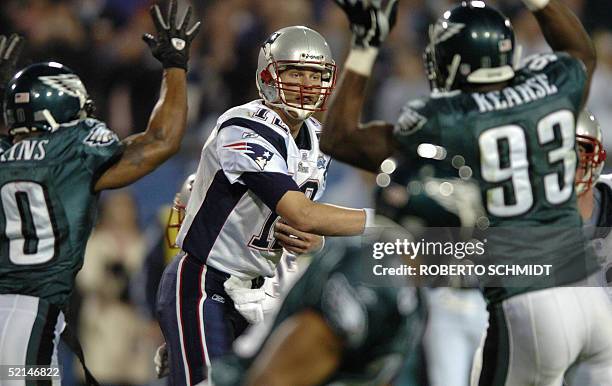 New England Patriots quarterback Tom Brady throws a pass while being pressured by the Philadelphia Eagles defense during the second quarter of Super...