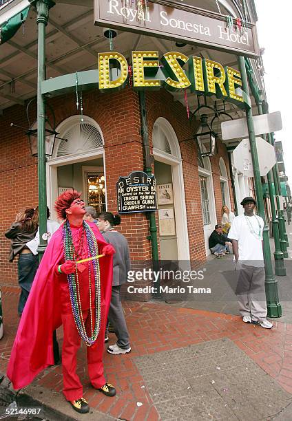 Reveler dressed as the Devil stands on Bourbon Street during Mardi Gras festivites February 6, 2005 in New Orleans, Louisiana. Festivities will...