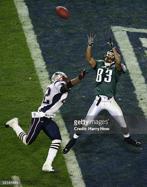 Wide receiver Greg Lewis of the Philadelphia Eagles catches a touchdown pass over safety Dexter Reid of the New England Patriots in the fourth...