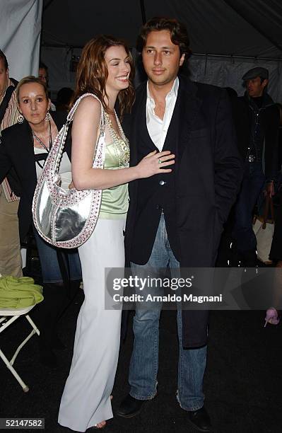 Anne Hathaway and Raphaello Foglieri attend the Luca Luca Fall 2005 during Olympus Fashion week at Bryant Park February 6, 2005 in New York City.