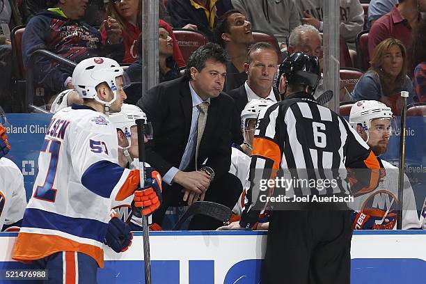 Referee Francis Charron talks to Head coach Jack Capuano of the New York Islanders regarding the fighting penalties against the Florida Panthers in...