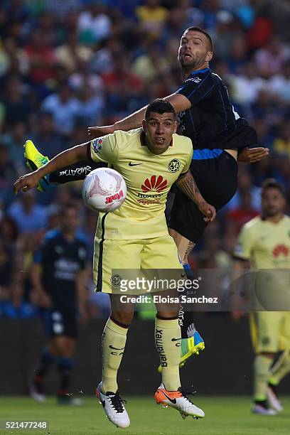 Emanuel Villa of Queretaro jumps for the ball with Erik Pimentel of America during the 14th round match between Queretaro and America as part of the...