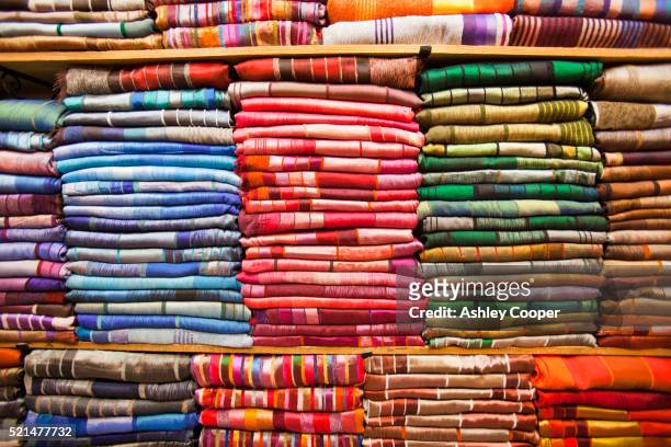 traditional moroccan cloth in a souk in marrakech, morocco, north africa. - north africa fotografías e imágenes de stock