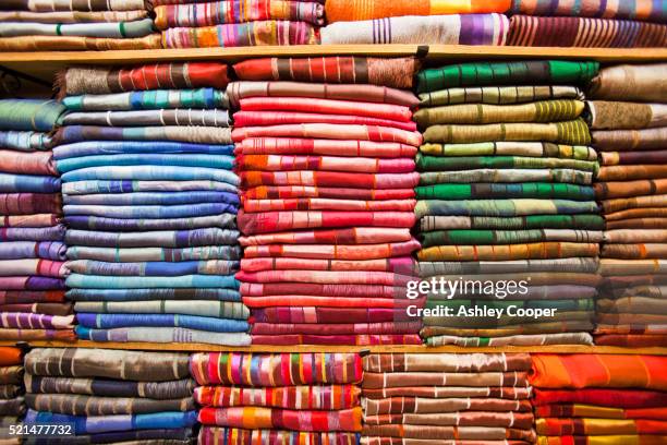 traditional moroccan cloth in a souk in marrakech, morocco, north africa. - african textiles stockfoto's en -beelden