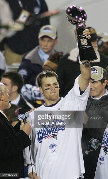 Quarterback Tom Brady of the New England Patriots celebrates with the Lombardi trophy after defeating the Philadelphia Eagles in Super Bowl XXXIX at...
