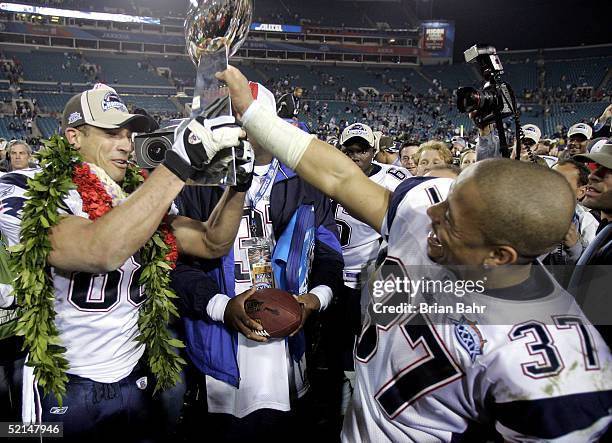 Rodney Harrison and Christian Fauria of the New England Patriots celebrate with the Lombardi Trophy after defeating the Philadelphia Eagles in Super...