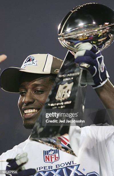 Wide receiver Deion Branch of the New England Patriots celebrates with the Lombardi trophy after defeating the Philadelphia Eagles in Super Bowl...