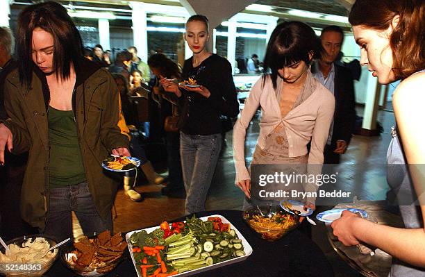 Models eat backstage at the Gary Graham Fall 2005 show during Olympus Fashion Week February 6, 2005 in New York City.